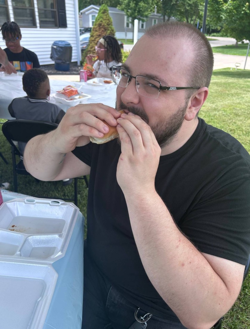 A Bayshore community resident eats a hot dog