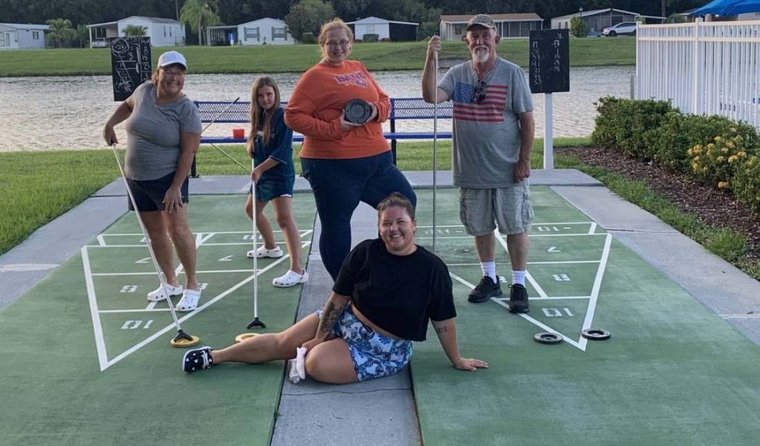 A group of Bayshore residents play shuffleboard by the water