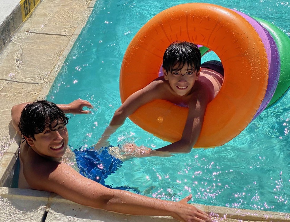 Two boys play in the pool at a Bayshore manufactured home community