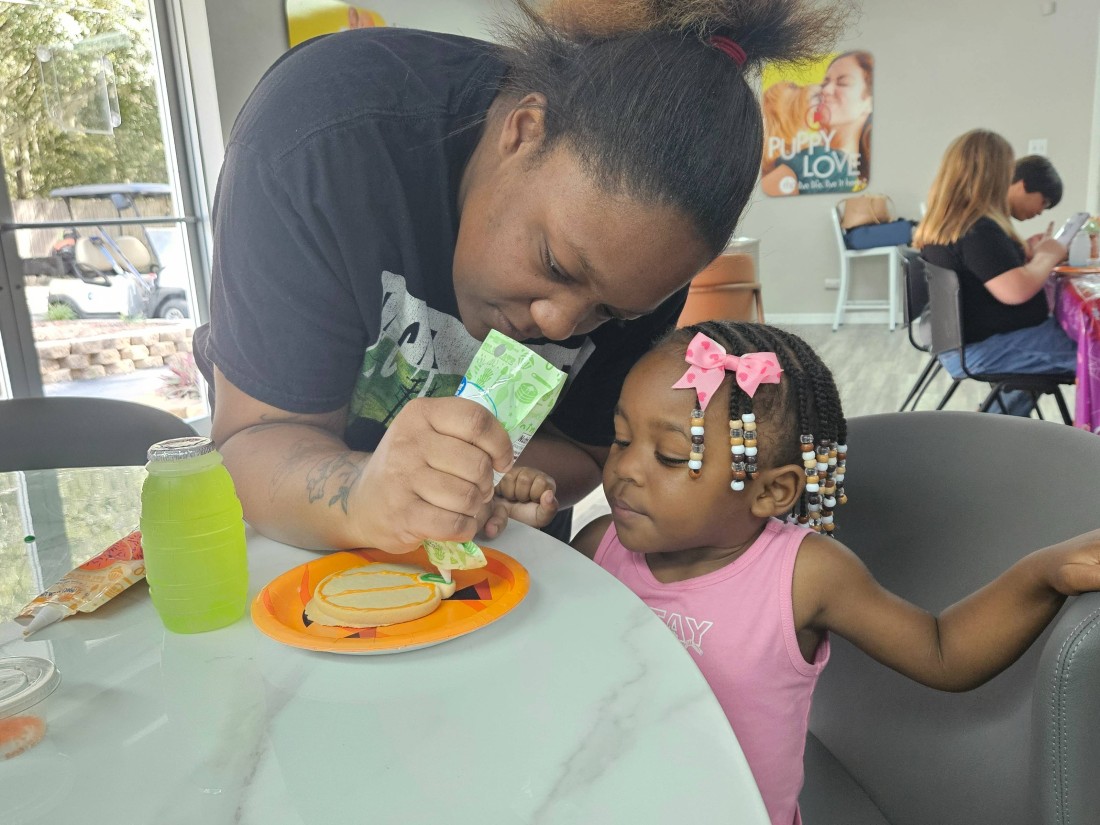 RHP families decorate cookies during a community event