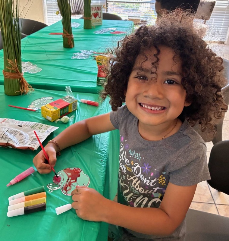 A young girl makes and arts and crafts project for her teacher with Bayshore manufactured home communities