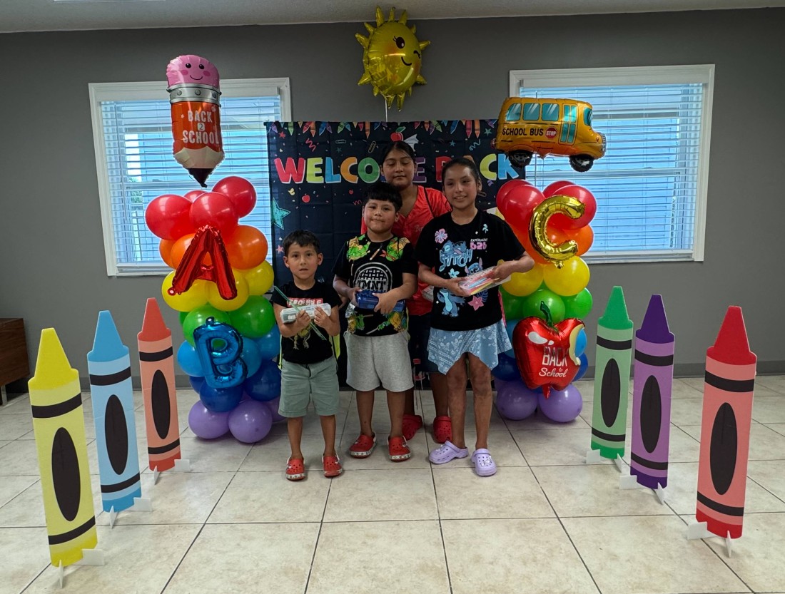 Kids in front of a back to school display at an event hosted by RHP Social and Bayshore Manufactured Homes