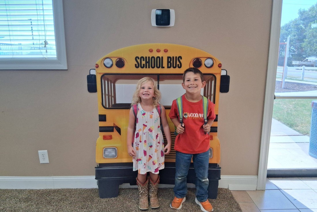 Kids in front of a school bus display for first-day photo fun at a Bayshore manufactured home community