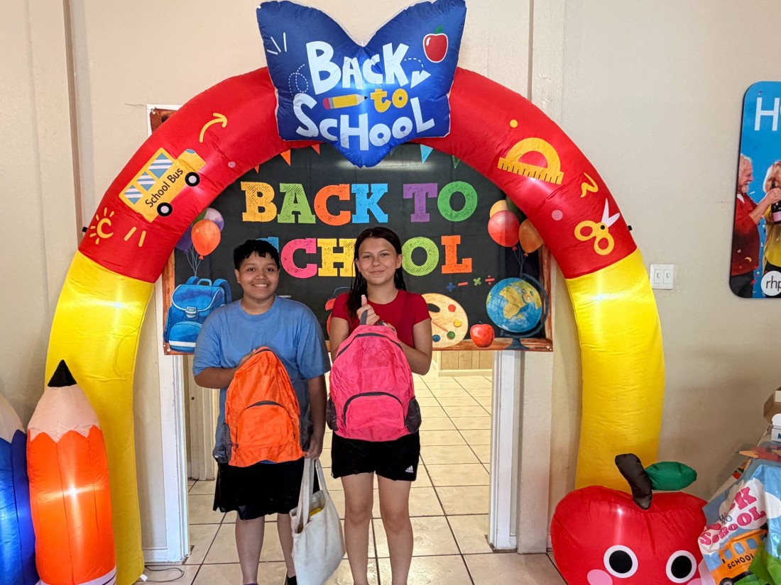Children holding backpacks at a Bayshore & RHP Social Back to School Bash