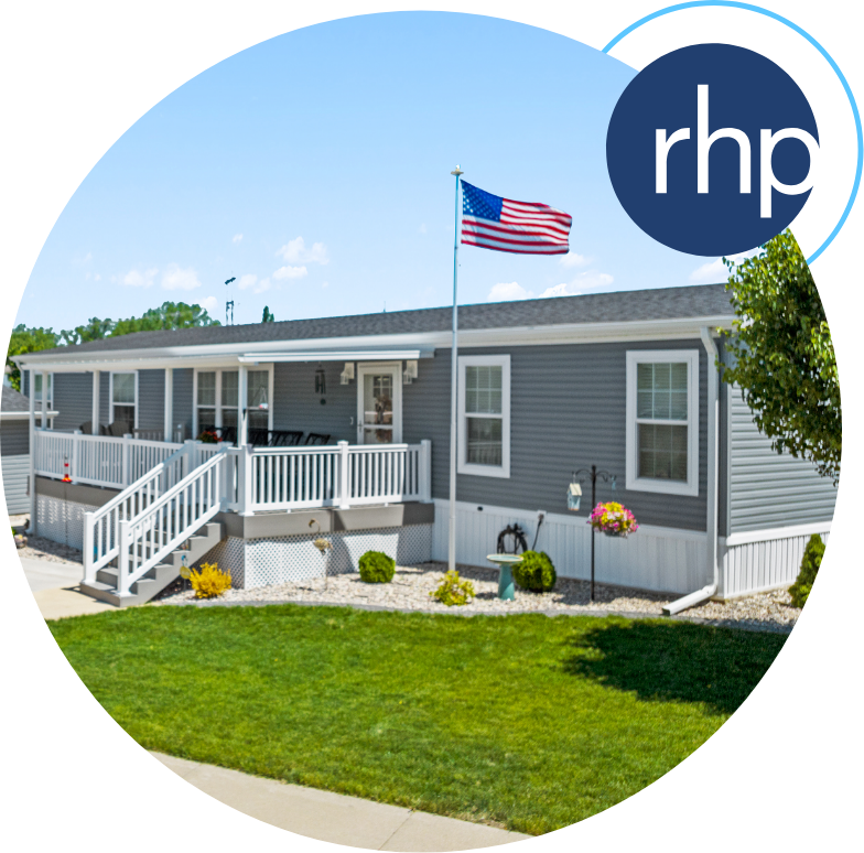Manufactured home with a white porch and US flag on a pole in the front