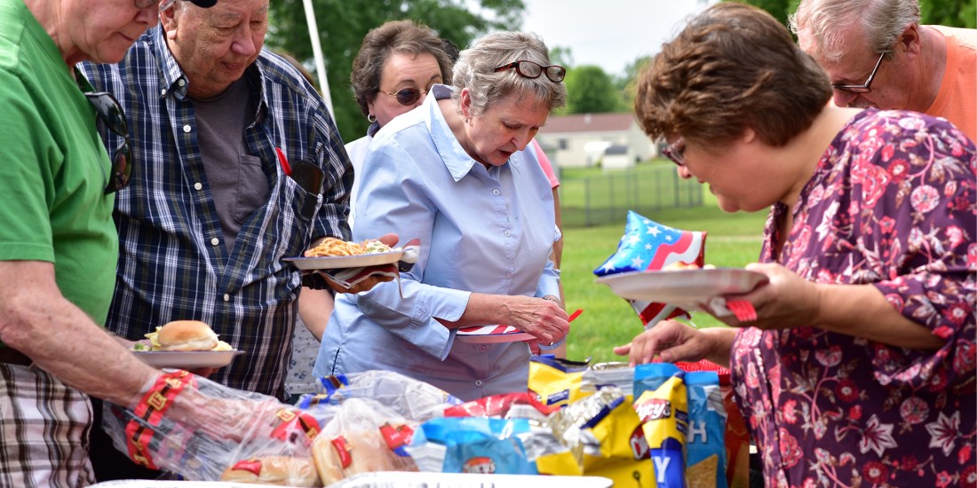 Community members at Eagle Crest manufactured home community enjoy an outdoor summer party