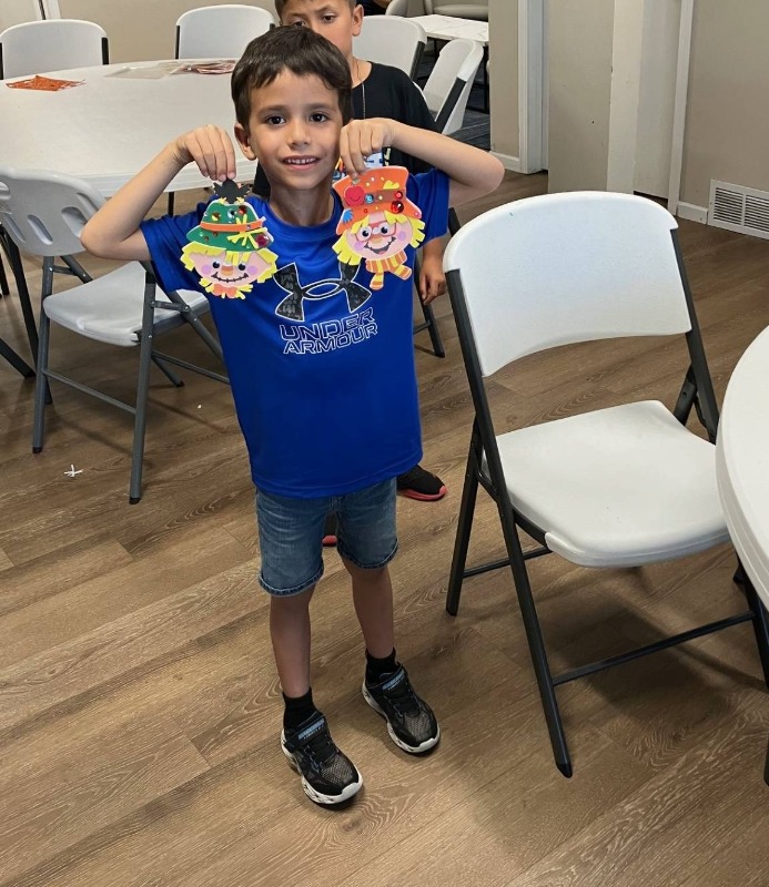 A young boy participates in Bayshore Manufactured Home Community's make a scarecrow event