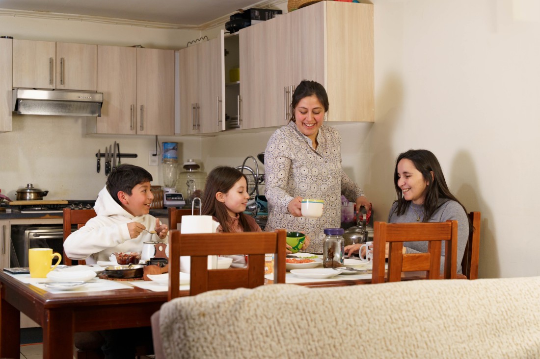 A family enjoys breakfast together in a manufactured home kitchen. 