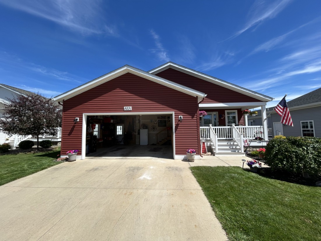A manufactured home with garage and porch in the Hidden Creek community of Holland, MI